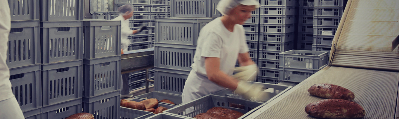 Photo for illustration purposes of a woman working in a bread factory