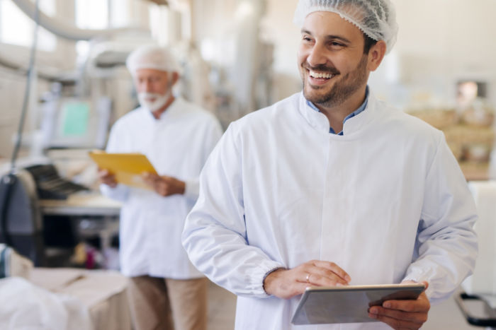 Man in bakery with tablet computer